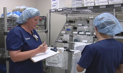 Hospital personnel taking inventory of product in a supply room.