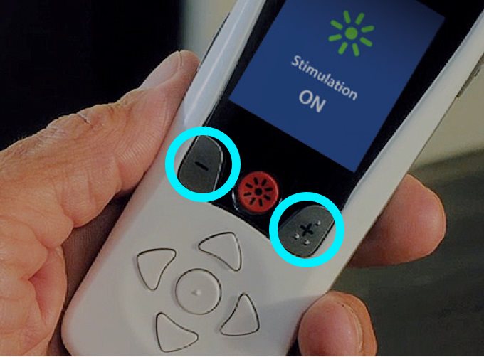 Person holding remote with the plus and minus buttons highlighted