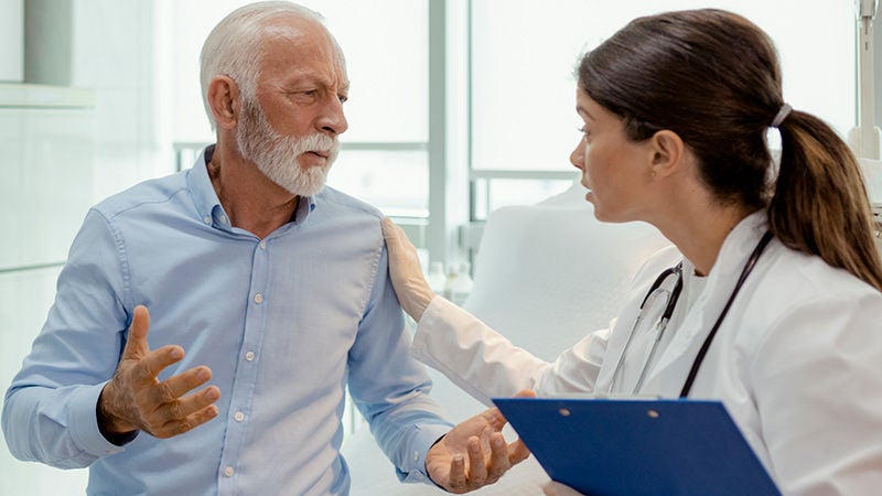 Senior patient speaking with a doctor during a medical consultation at a clinic