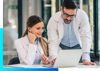 Two healthcare professionals using a laptop.