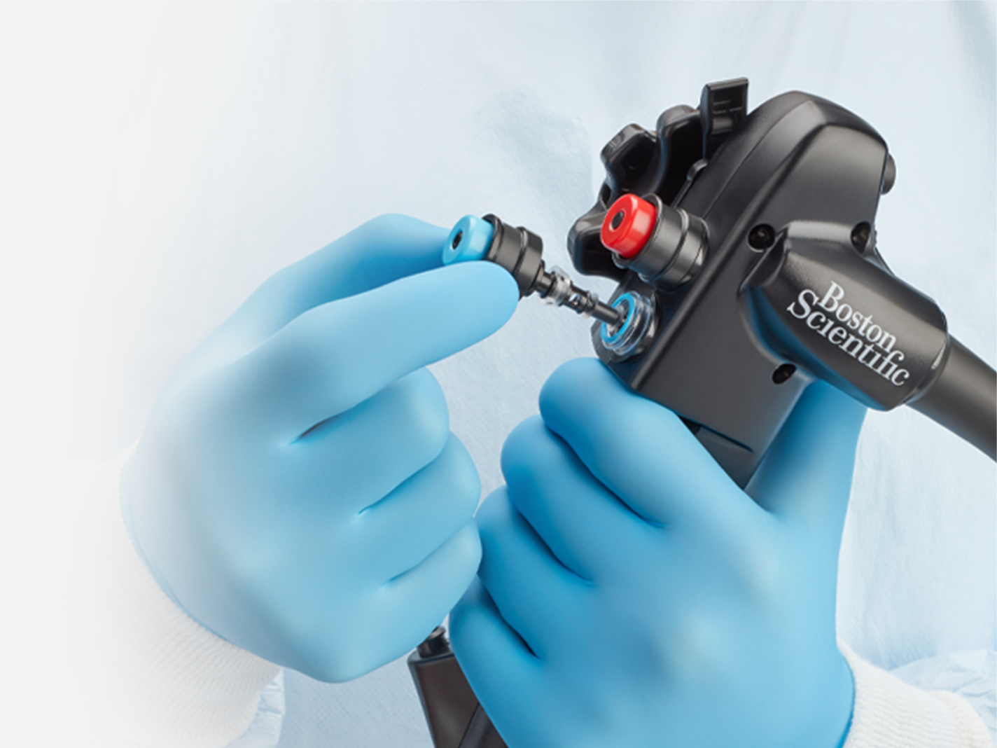 Physician holding an EXALT™ Model D Single-Use Duodenoscope with Orca Generation 2 Single-Use Air/Water and Suction Valves. 