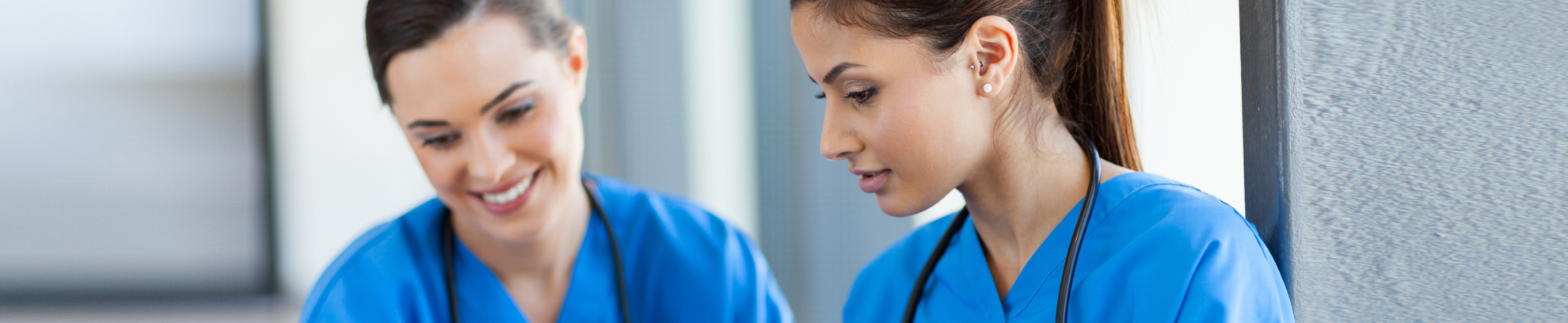 two nurses in scrubs talking