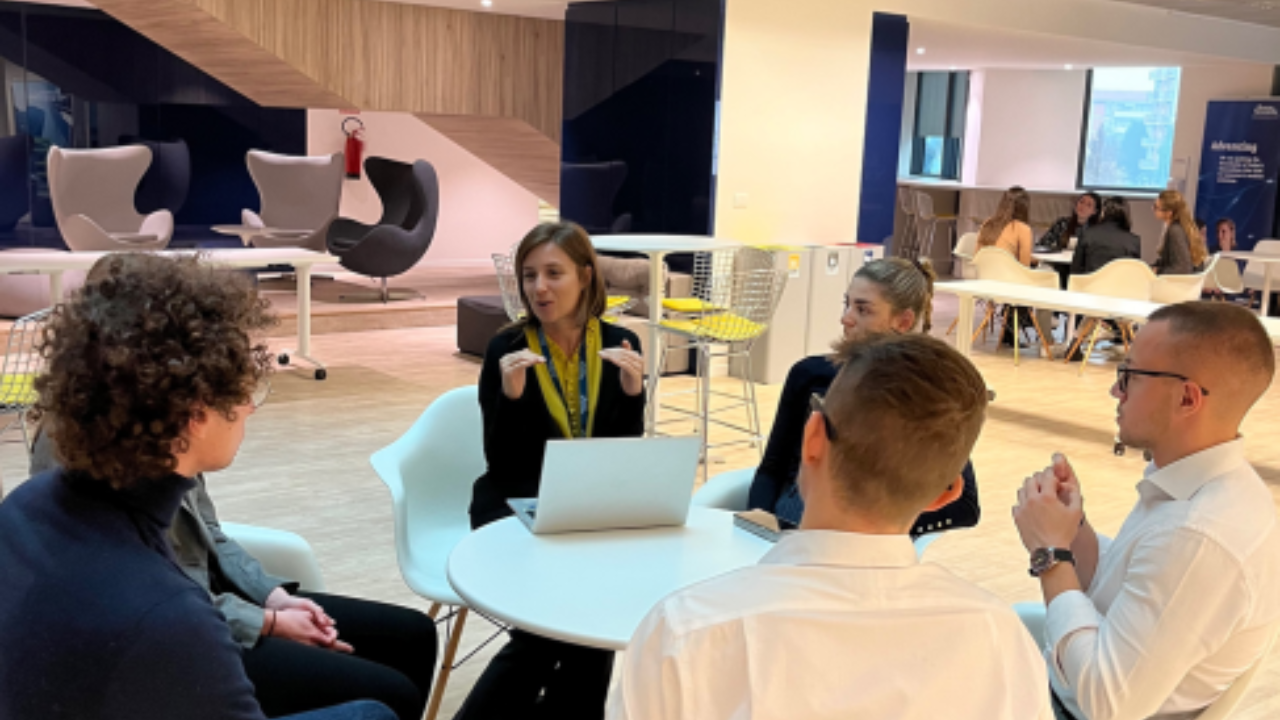 Young graduates listening to company mentor