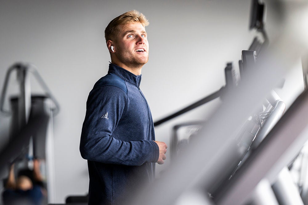Employee exercising on a treadmill, promoting health and wellness in support of employee well-being initiatives.