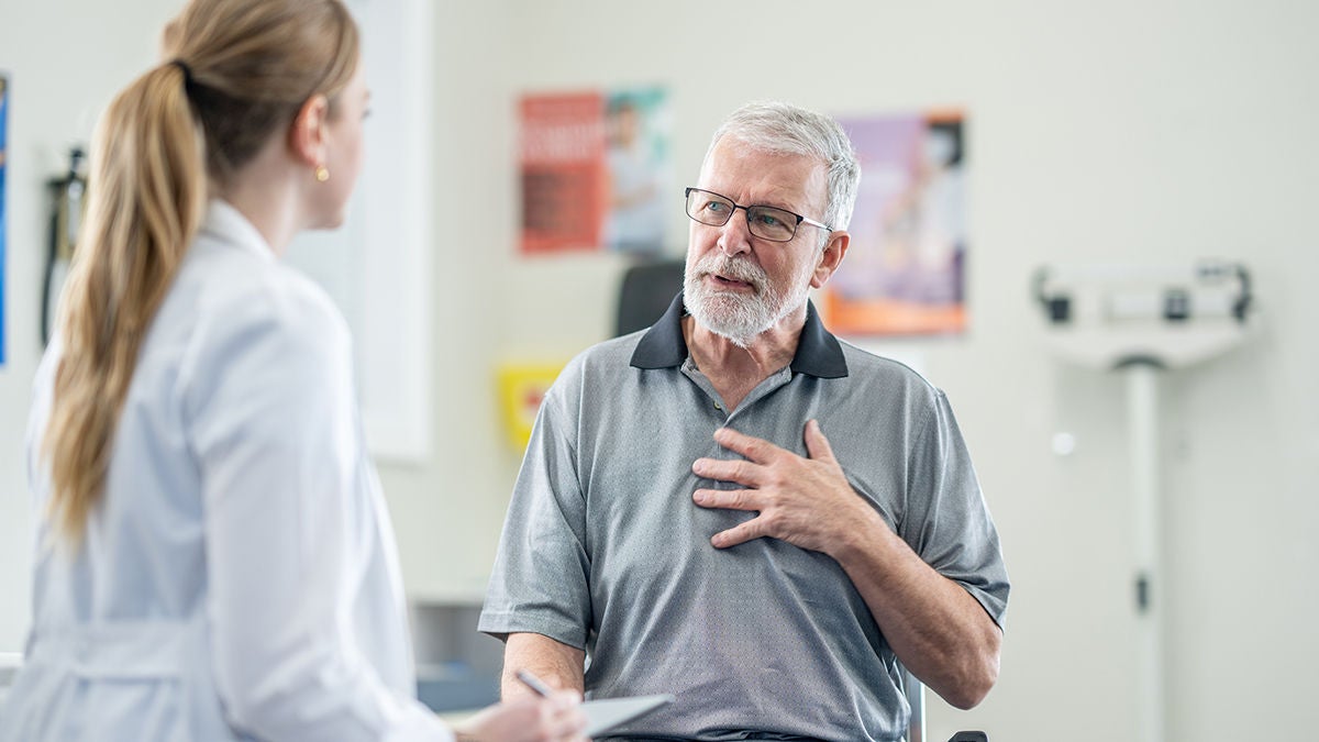 Doctor consulting with senior patient to support referral acceleration and timely care