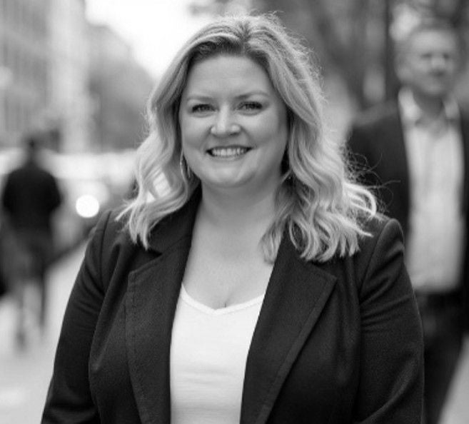 Black and white headshot of white women in black coat.