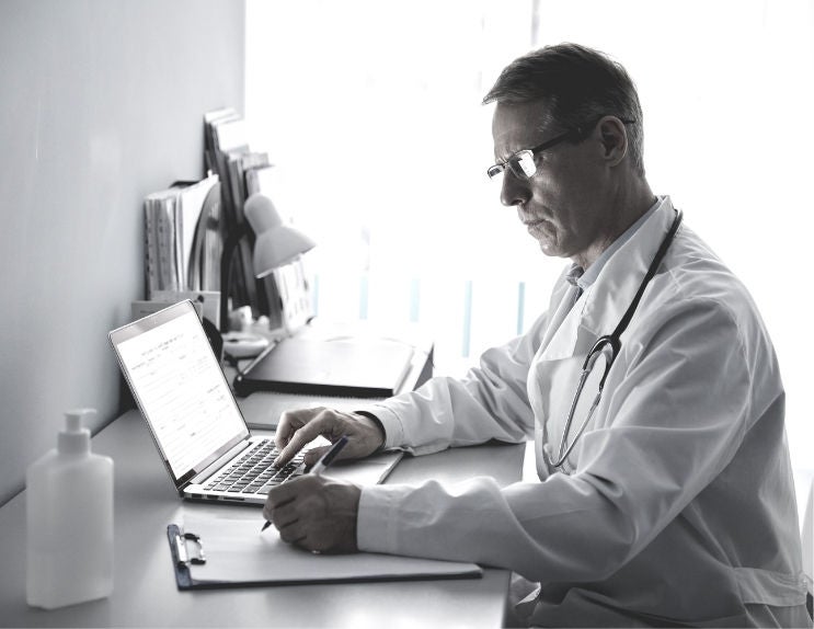 physicians doing research on laptop