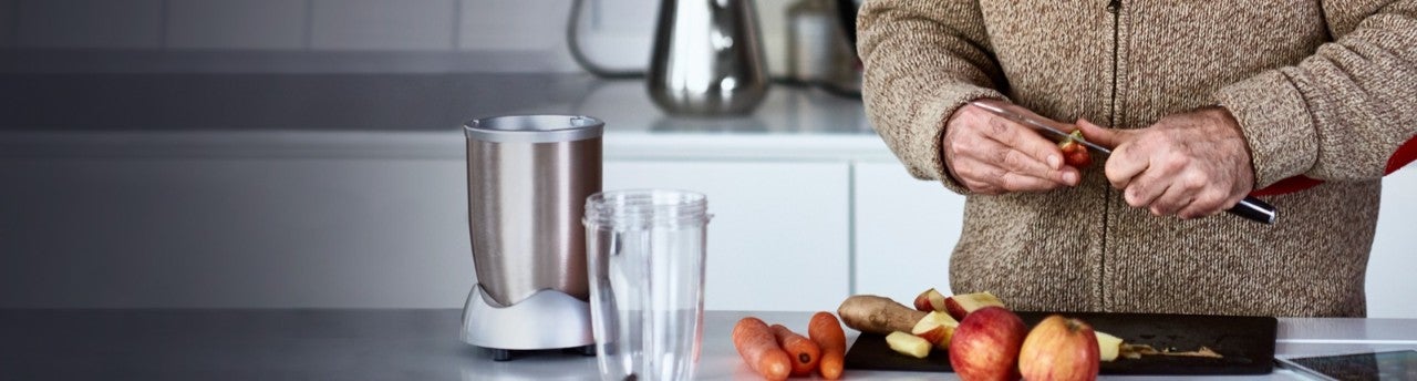 Husband and wife in a kitchen preparing a meal