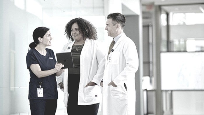 two clinicians with staff