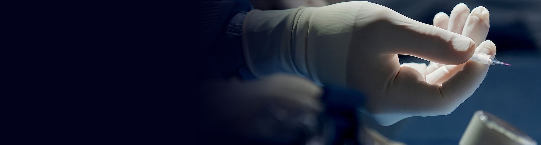 Healthcare worker's gloved hand holding Ranger DCB