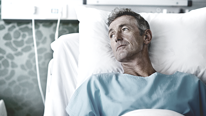 Patient laying on hospital bed looking up