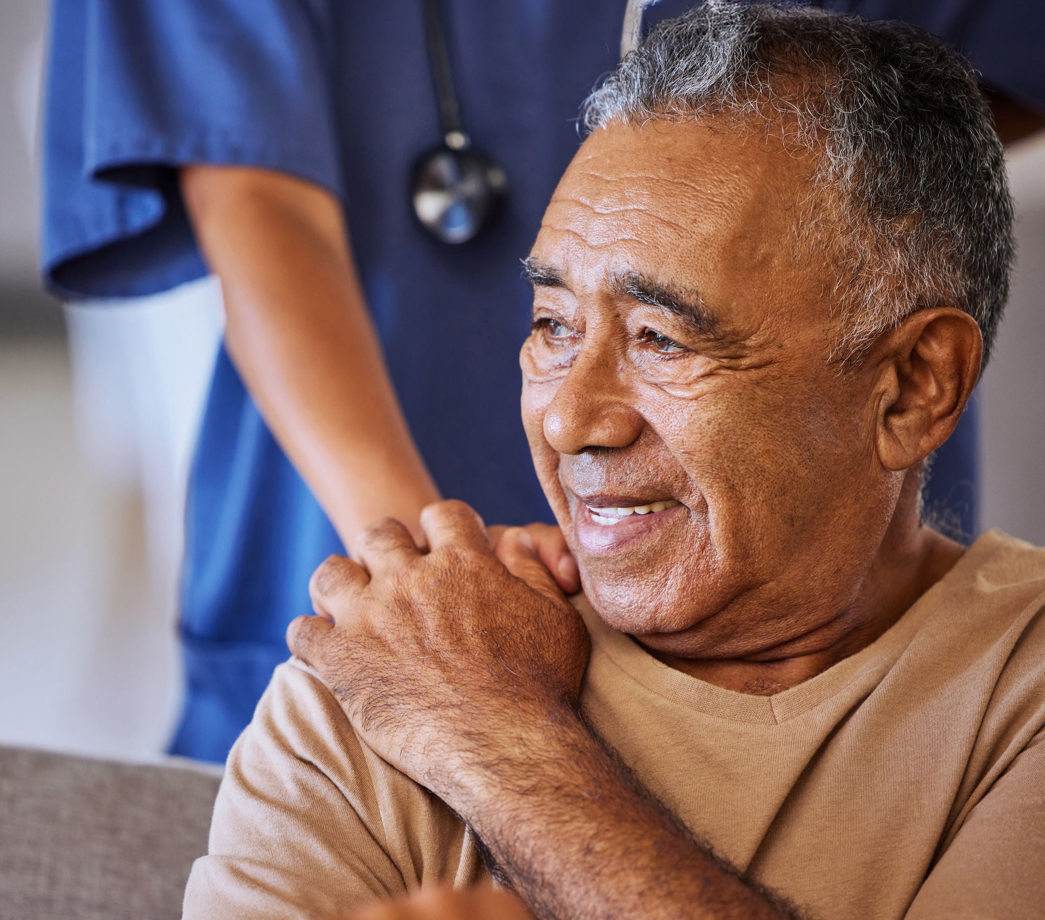 Old patient holding hand of doctor.