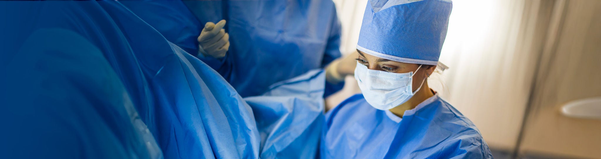 Closeup of physician in operating room.