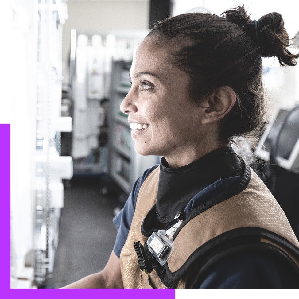 Volunteers wearing Boston Scientific t-shirts pose with a doc while smiling into the camera.