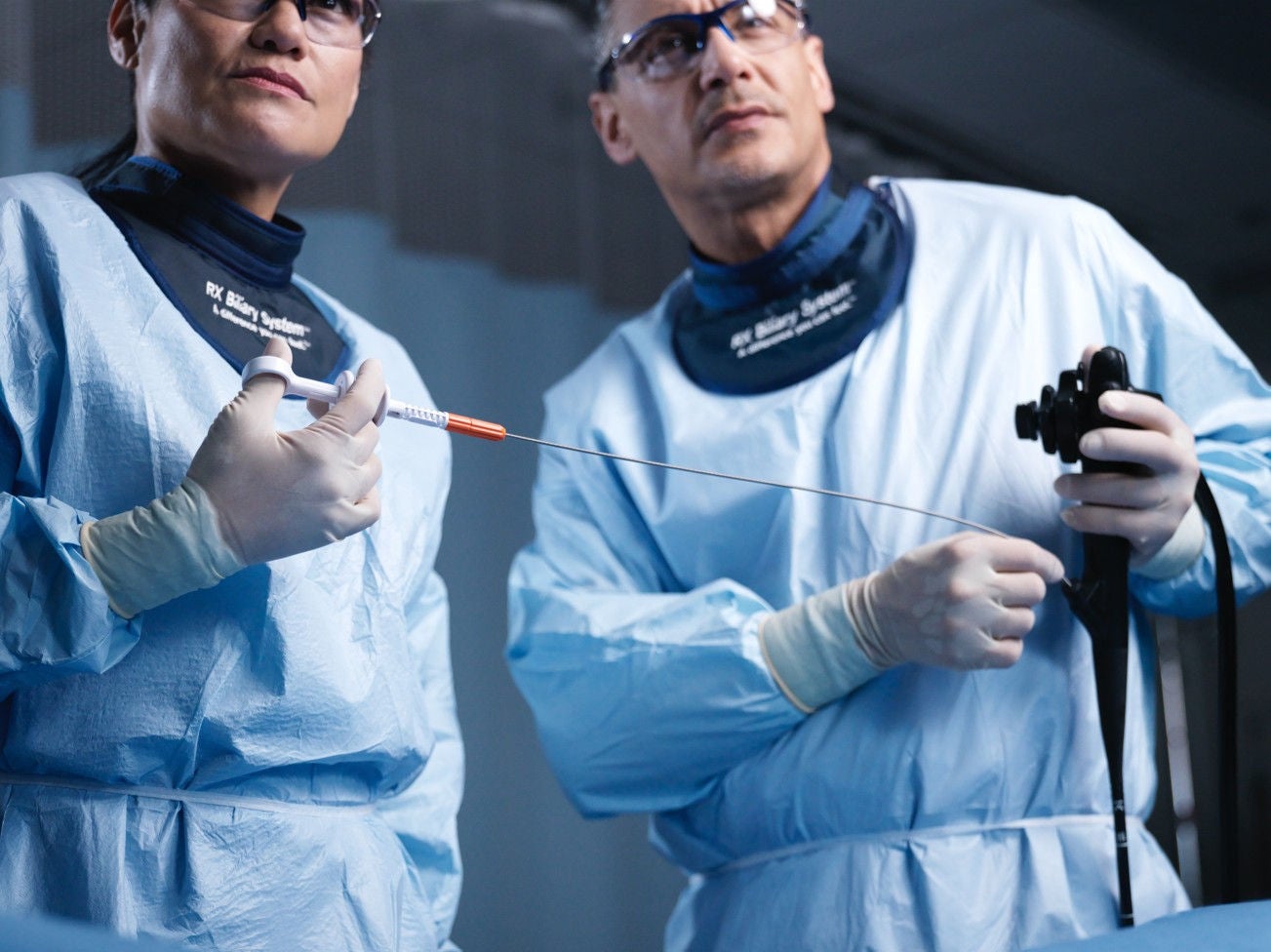 Health care providers holding medical devices.