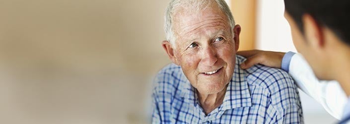 Healthcare provider gesturing as he converses with patient.