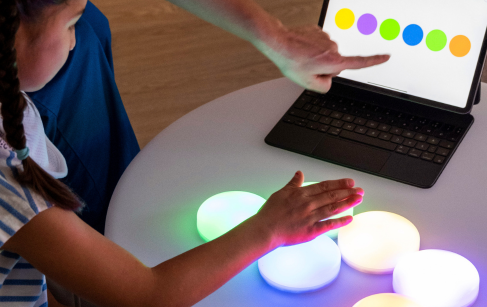 child-playing-with-innovative-assistive-technology-assisted-by-an-educator