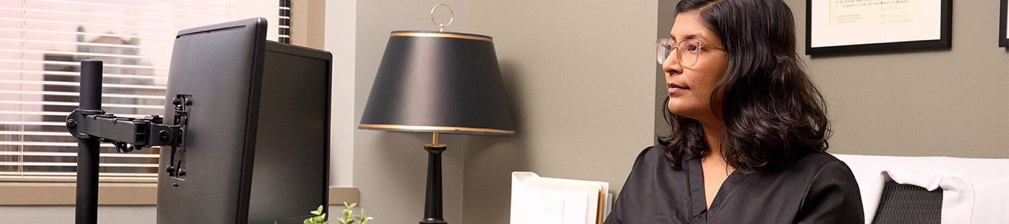 Healthcare provider working at computer.