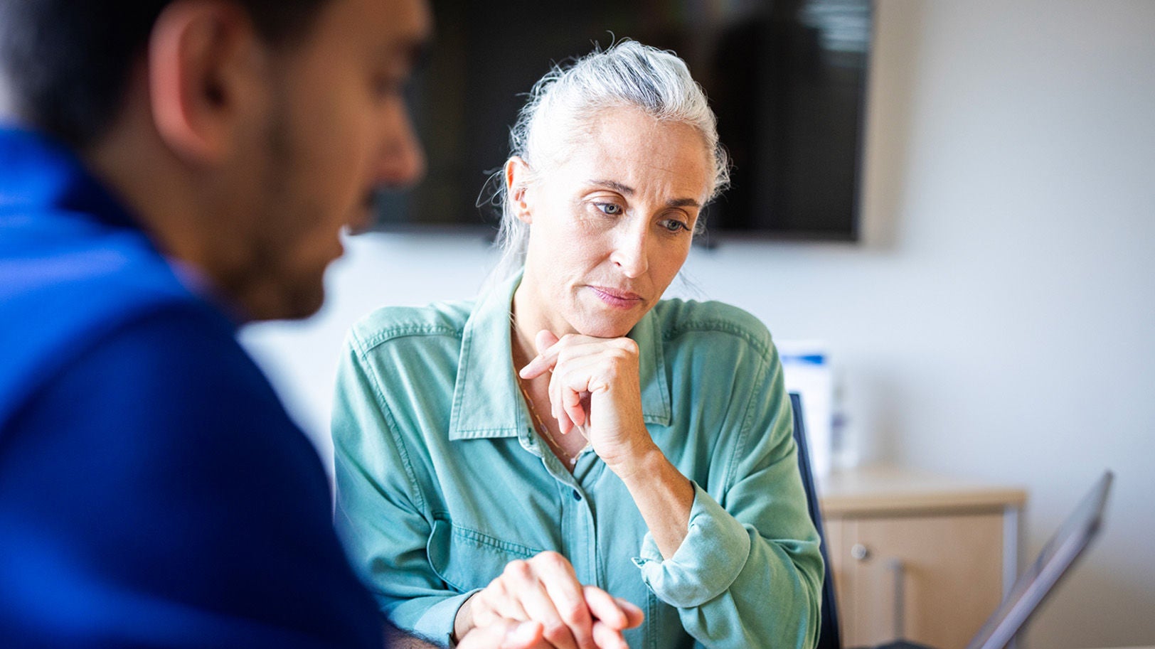 Physician talking to a female patient.