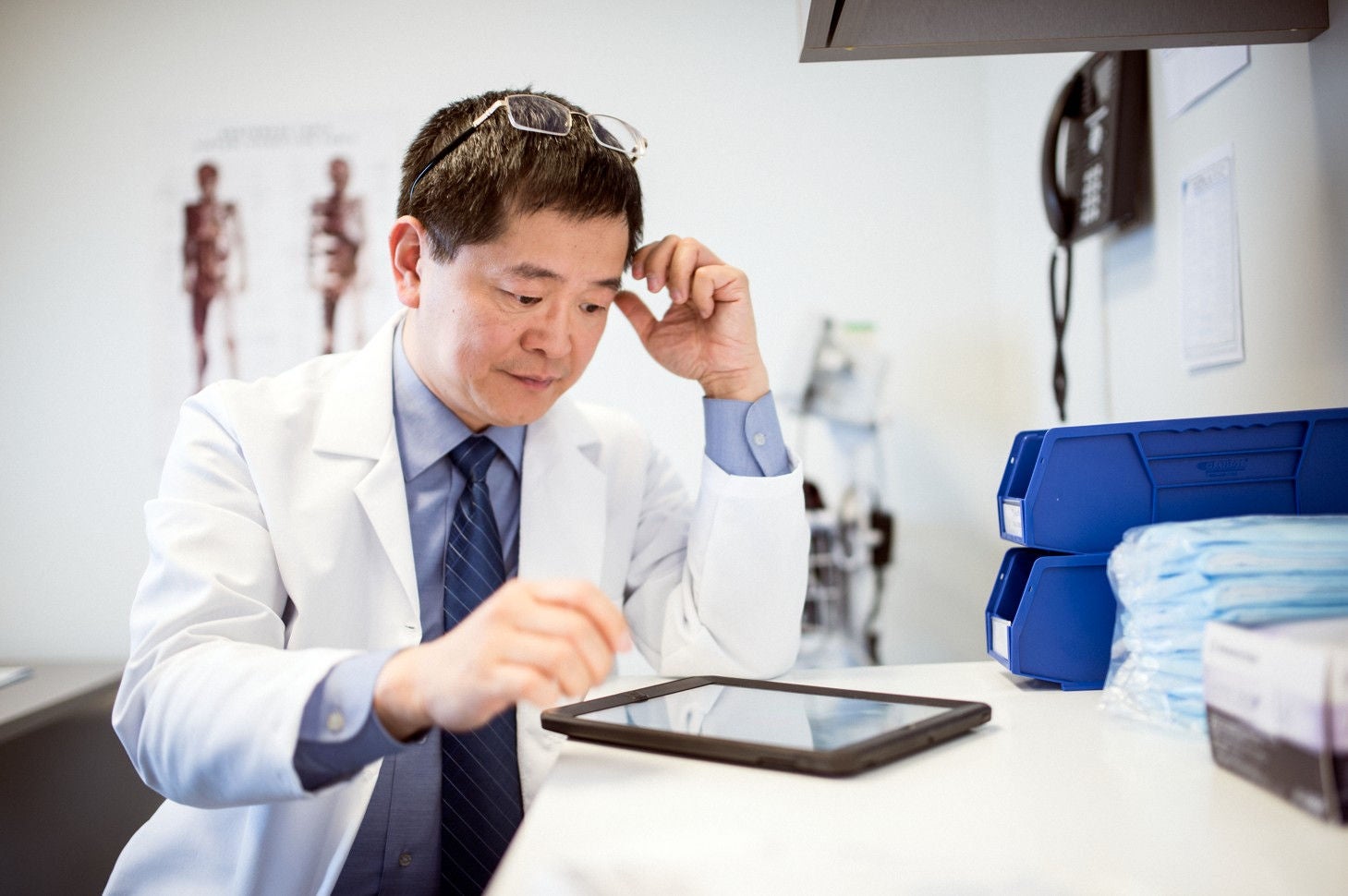 Healthcare provider working at tablet.