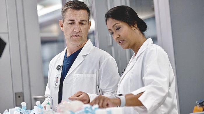 man and woman with labcoats