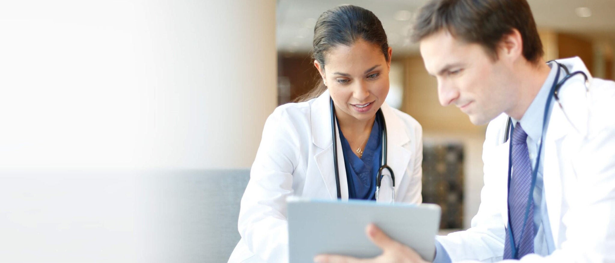 two doctors looking at a tablet