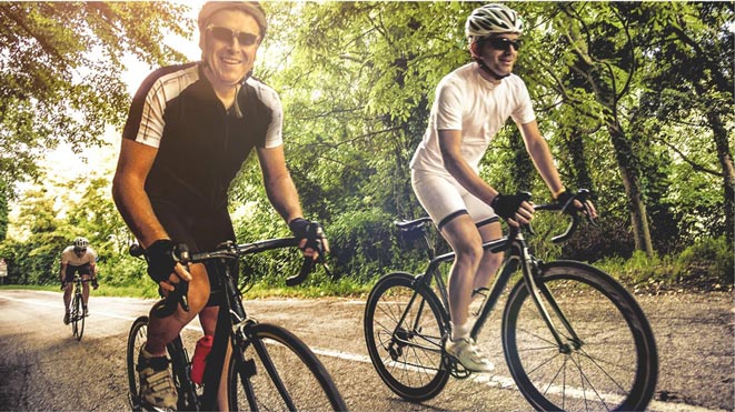 Three men biking on a road