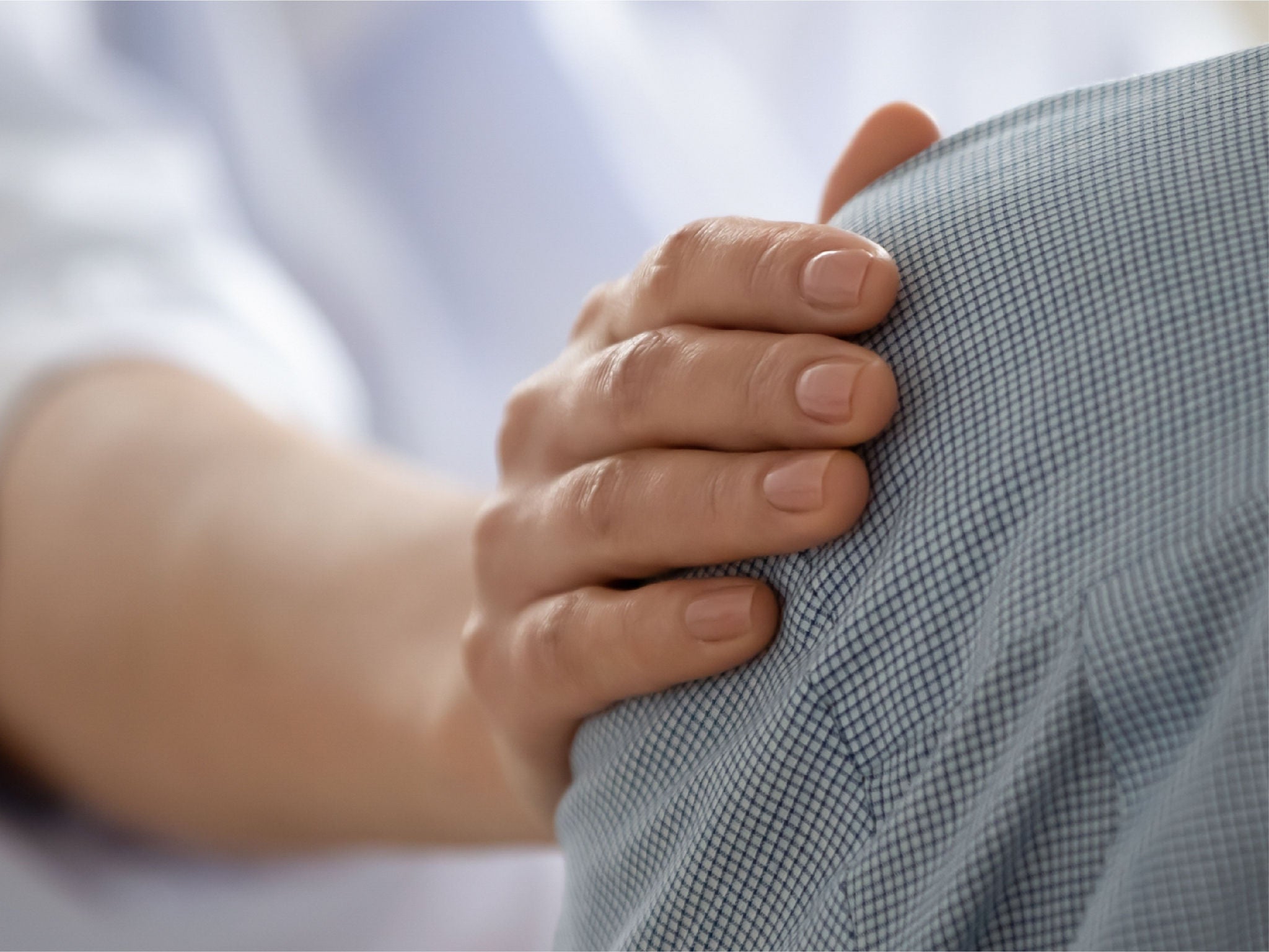 Hand on shoulder giving support, expressing that if experience matters, you should choose TheraSphere.