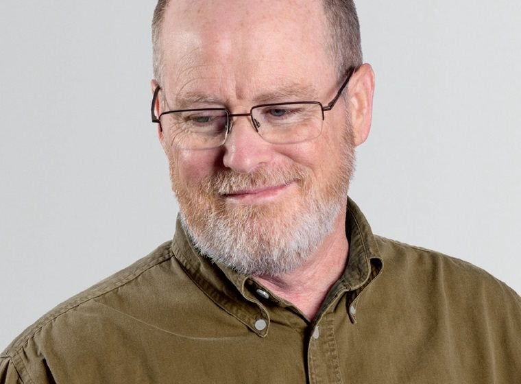 Man smiling and looking down 