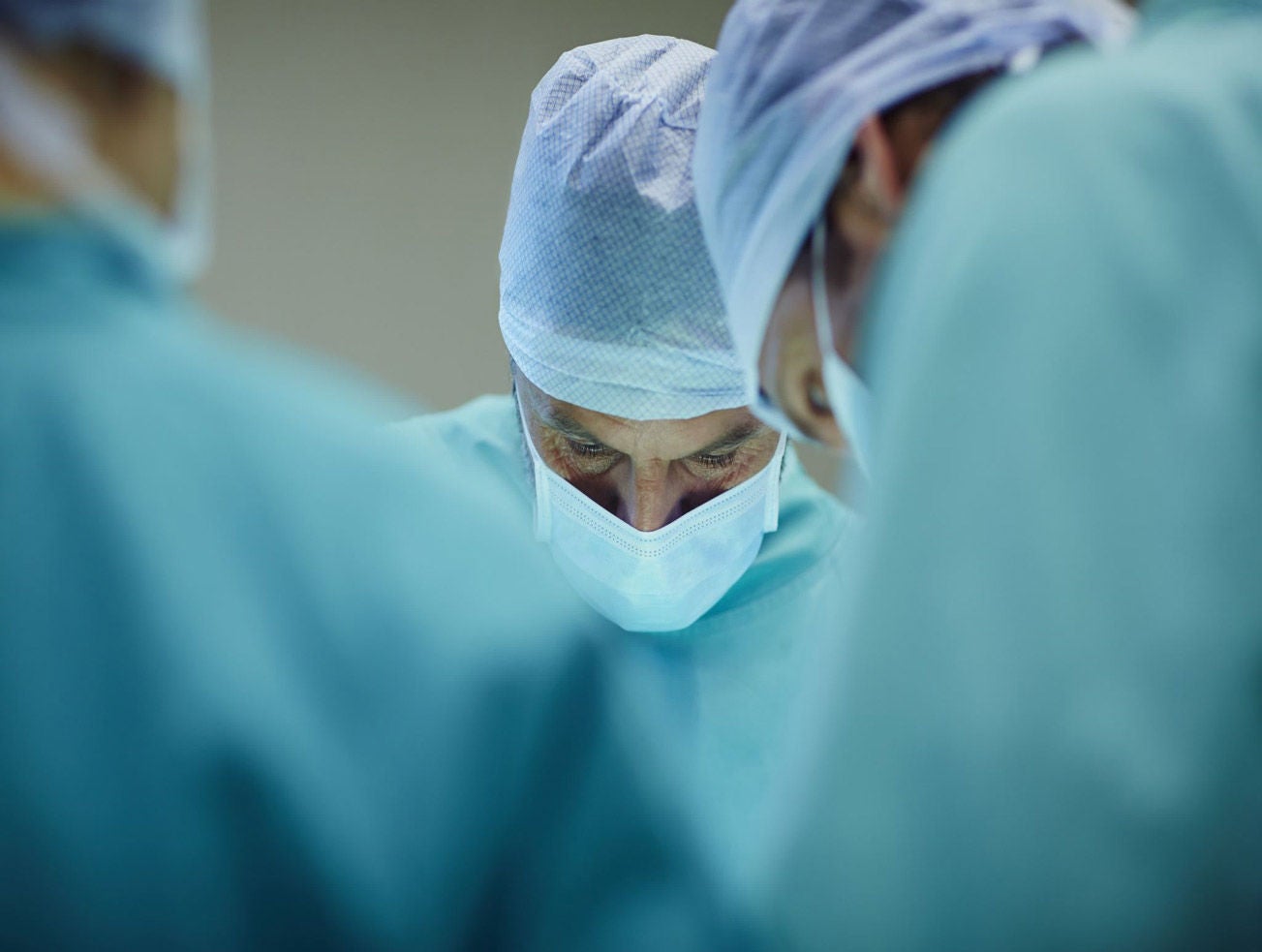 Surgeons looking down in procedure setting