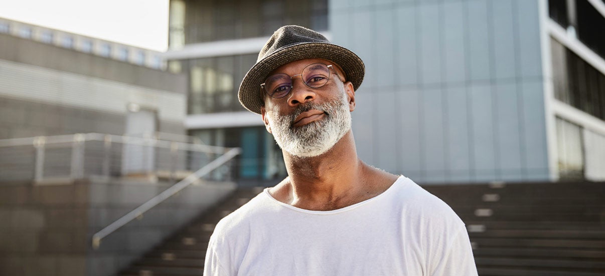 Man with a hat looking straight ahead 