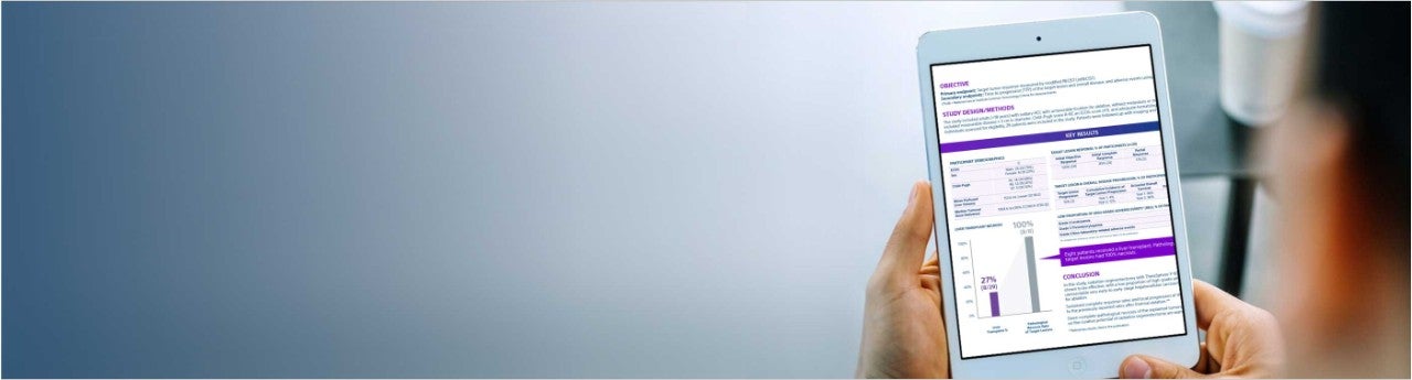 Person reading tablet with TheraSphere Y-90 Glass Microspheres information.