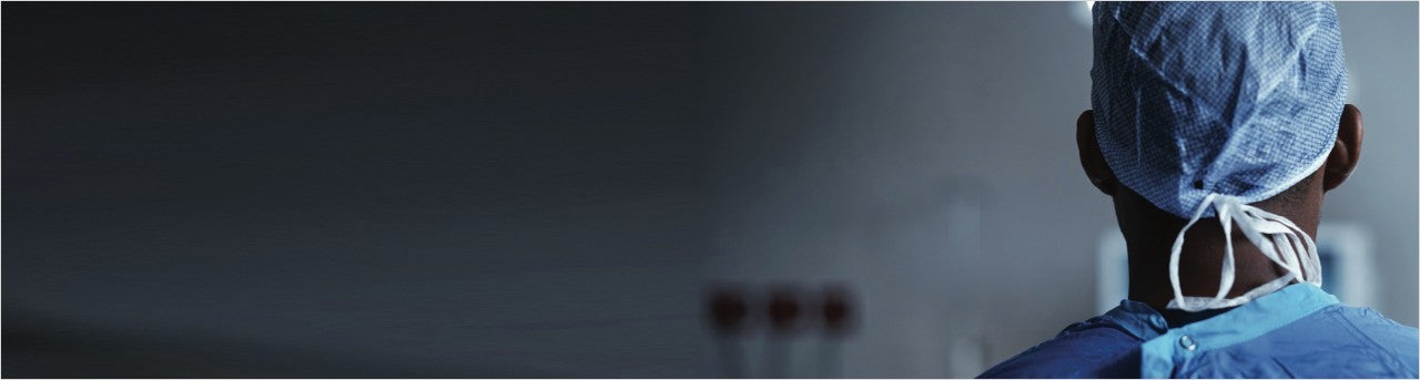 Healthcare provider standing with his back to us.