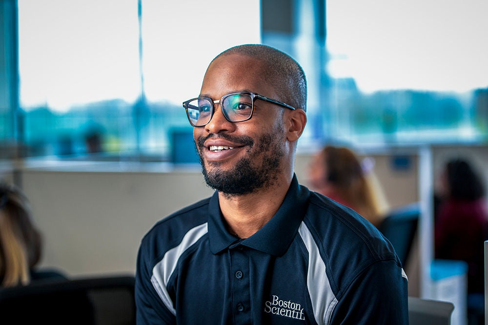 Office employee wearing Boston Scientific shirt.