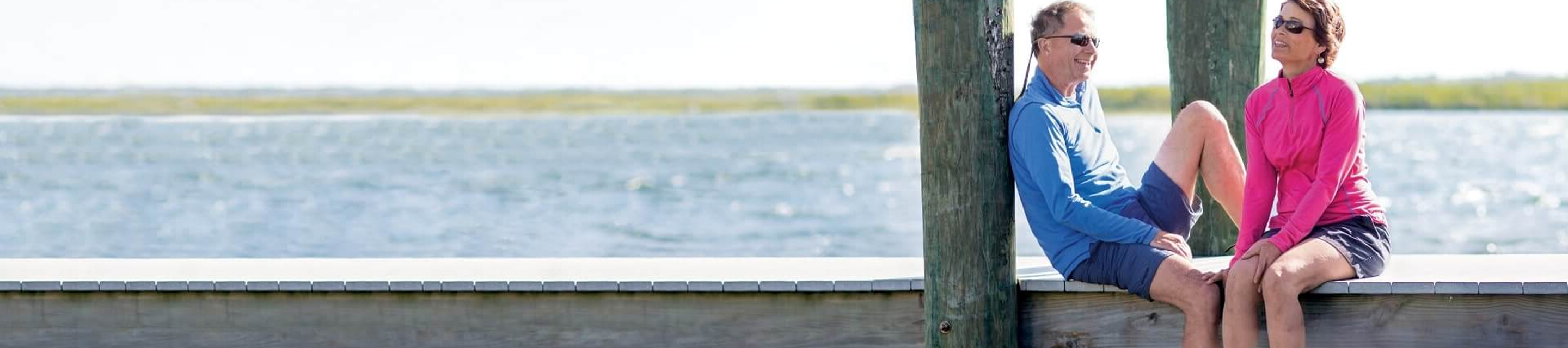 Neil with his wife on a dock.