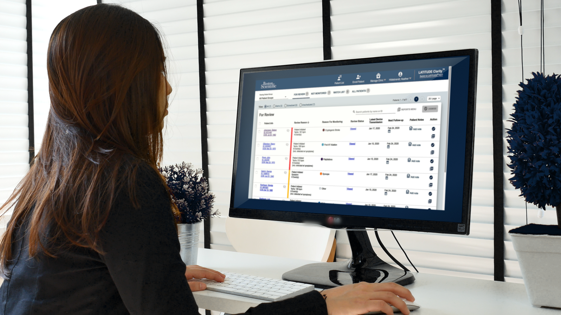 Women in front of a desktop monitor showing the LATITUDE Clarity Data Management System, a part of the LUX-Dx ICM System.