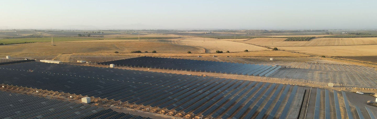 Large solar farm in rural landscape.
