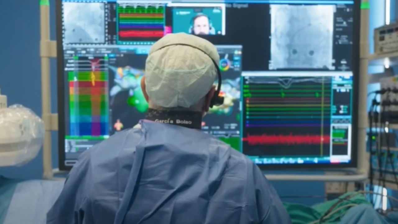 Physician seen from behind using remote healthcare technology