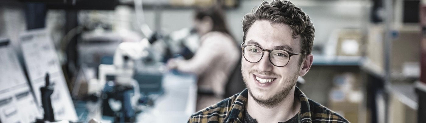 A young Boston Scientific's employee smiling in the office