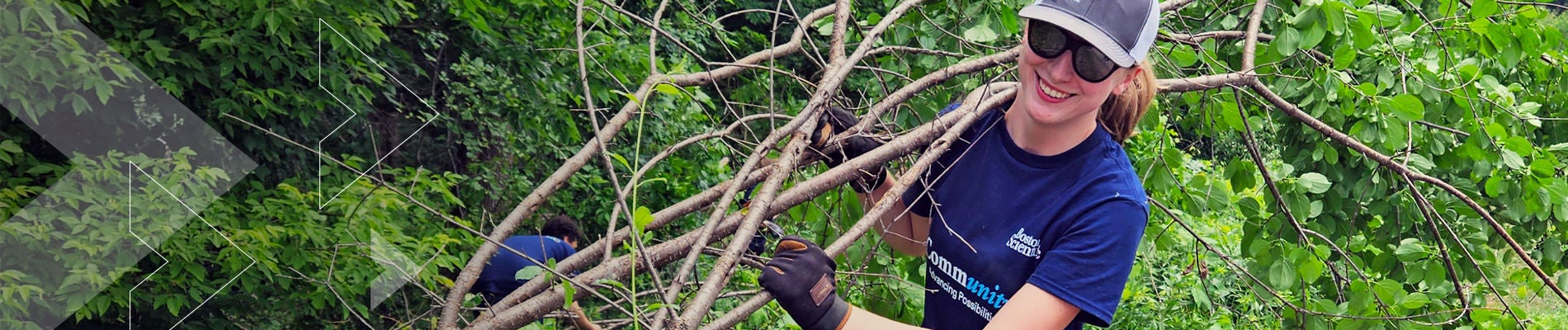 Woman employees wearing Boston Scientific t-shirts with protecting gloves inside jungle.