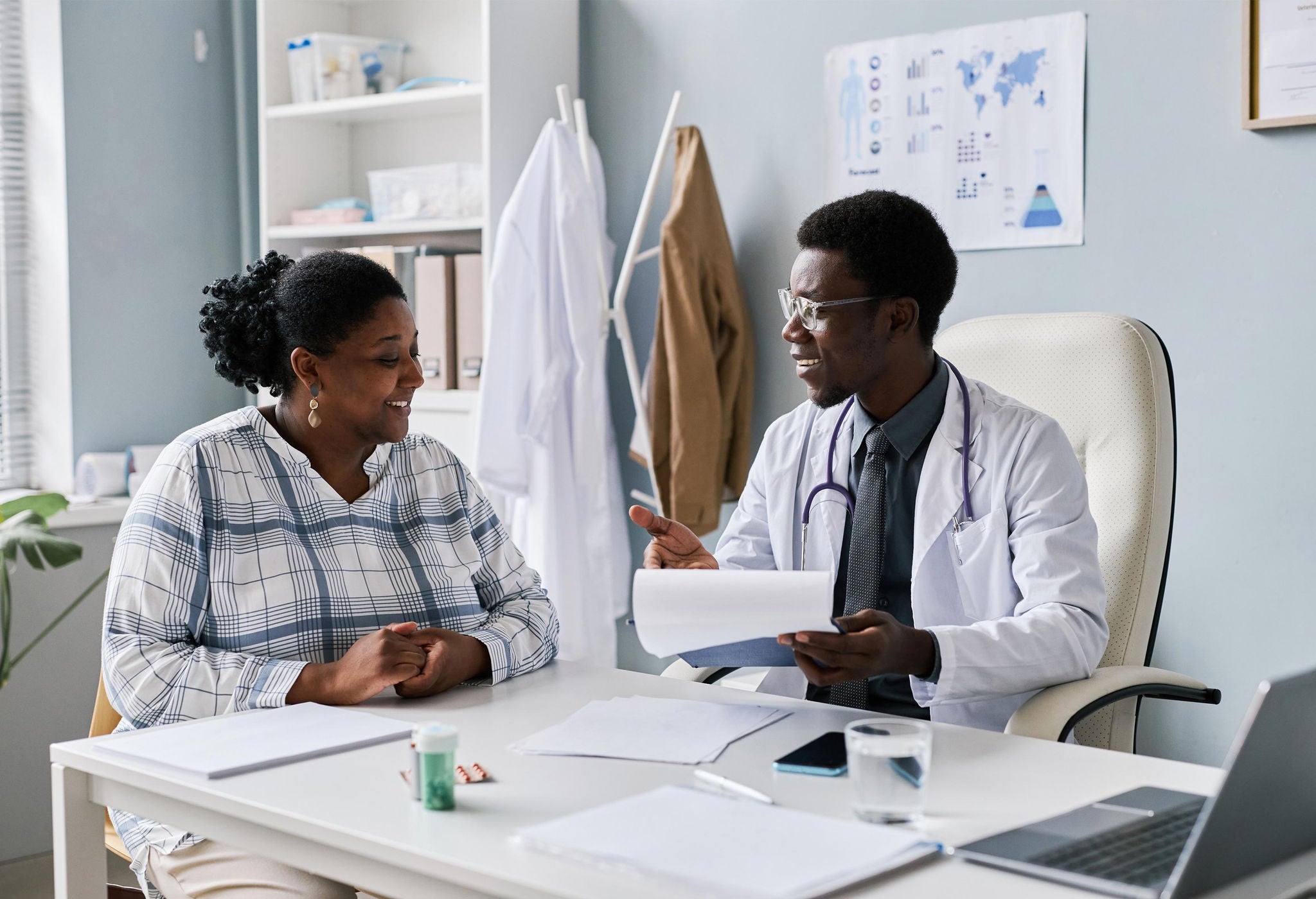 Doctor talking to patient in office