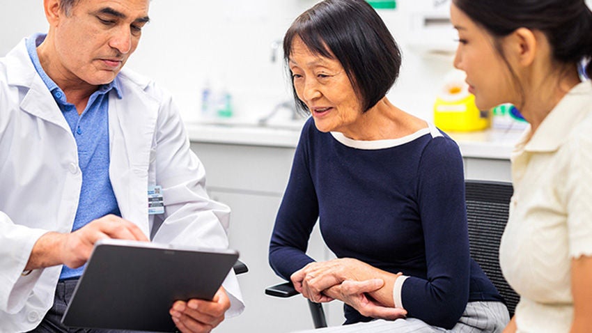 Physician reviewing stress urinary incontinence treatment options with patient.