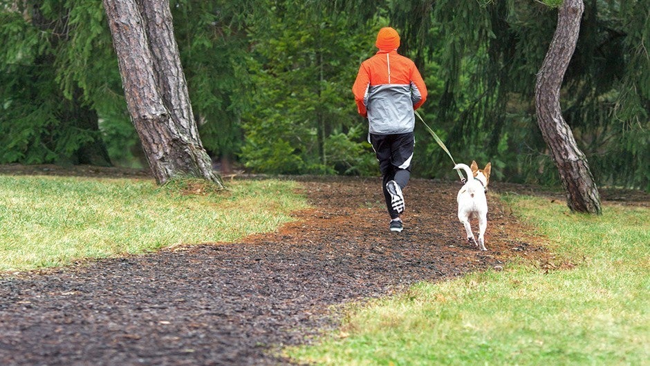 Woman exercising by running on a path in the outdoors.