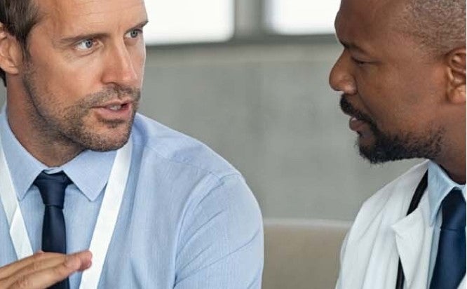 Businessman in deep conversation with a doctor