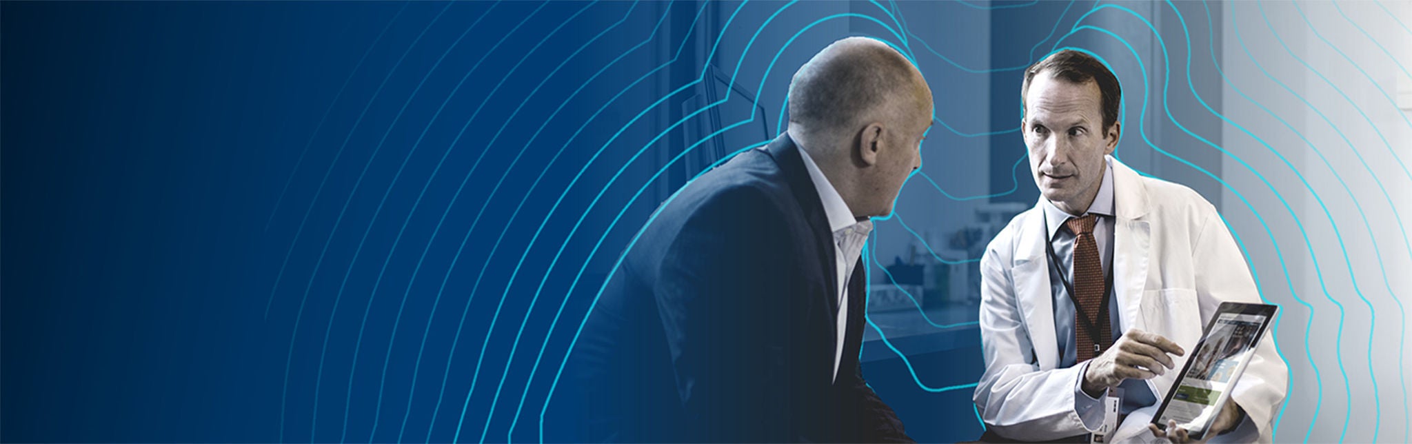 Urologist showing patient information on tablet.