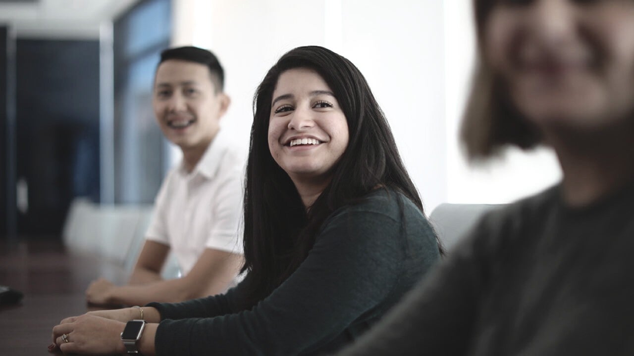 Upward view of trees against clear blue sky.