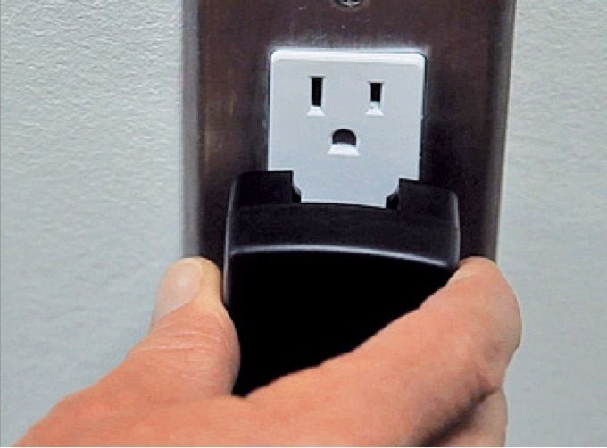 Person plugging charger into a wall  socket