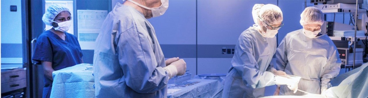 Four doctors performing surgery