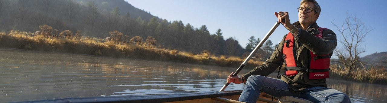 Man rowing on a lake in a canoe    