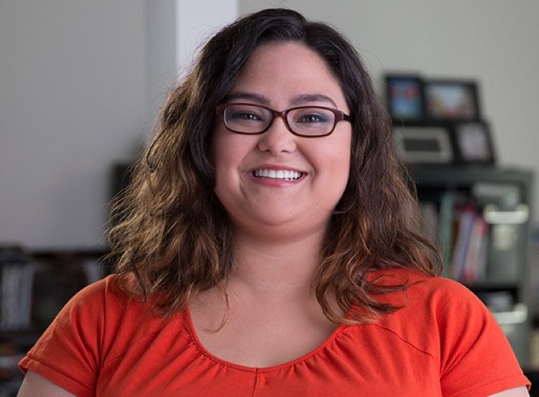 Woman smiling and looking directly ahead